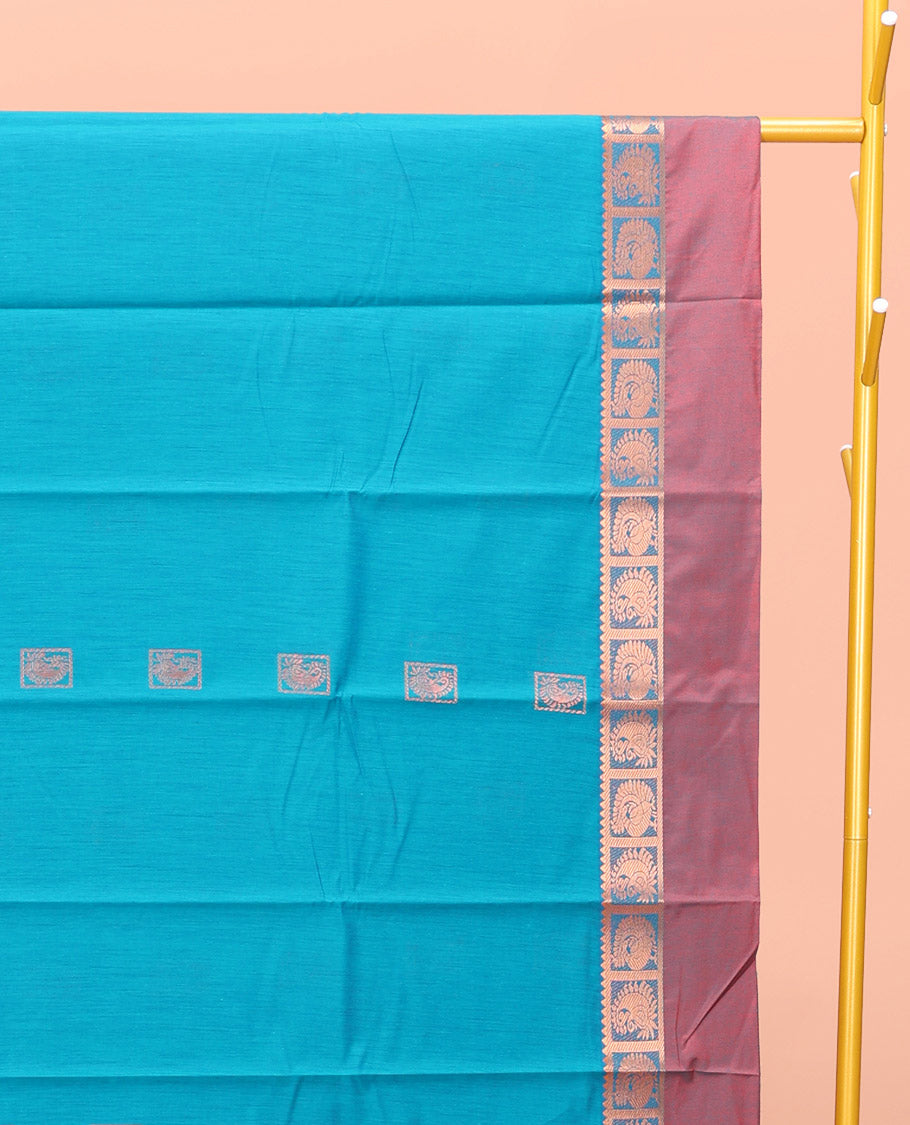 Blue Semi-Silk Cotton Saree, Decked Up with Zari Buttas All Over Its Body, Complemented by a Contrast Kal Eragina Border of Peacock Designs, Pallu Steeped with Elephant Zari Motifs, and Paired with a Matching Blouse