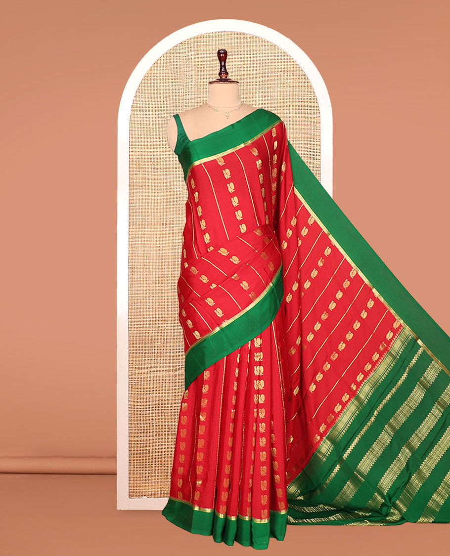 Red Mysore Silk Saree, Gracefully Adorned with Peacock Buttas and Stripes Across Its Body, Complemented by Contrast Border, Pallu Steeped with Traditional Zari Designs, and Paired with a Contrast Blouse