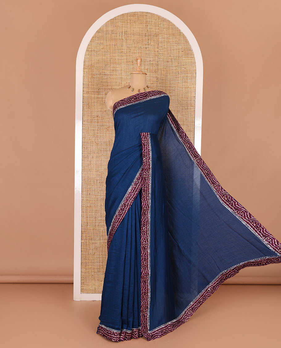 Blue plain Vichitra silk saree, contrast bandhani printed with Swarovski micro-stonework border, and a contrast bandhani printed blouse