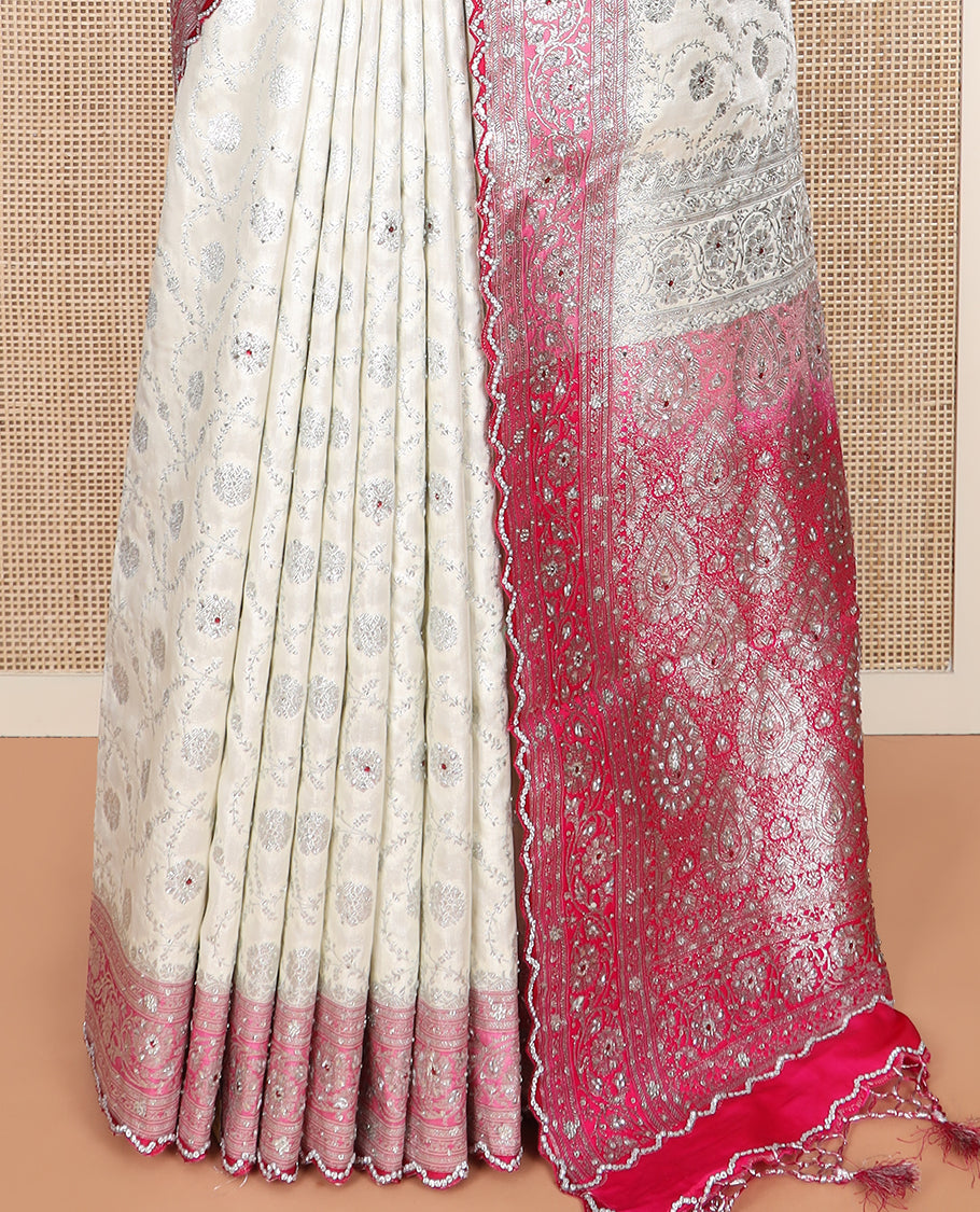 Pearl white floral jaal jacquard banarasi silk saree, contrast floral creeper stone work border, and pallu of intricate designs and stone work
