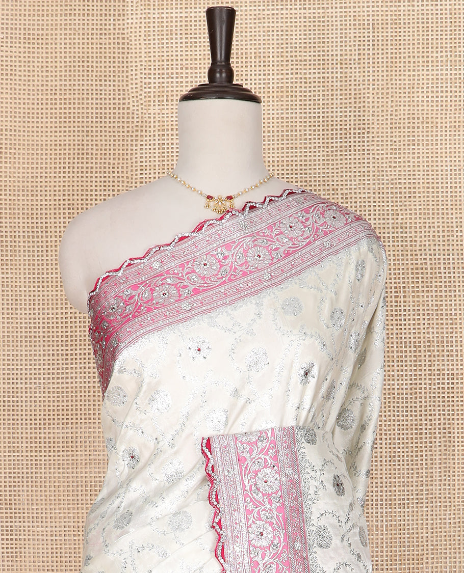 Pearl white floral jaal jacquard banarasi silk saree, contrast floral creeper stone work border, and pallu of intricate designs and stone work