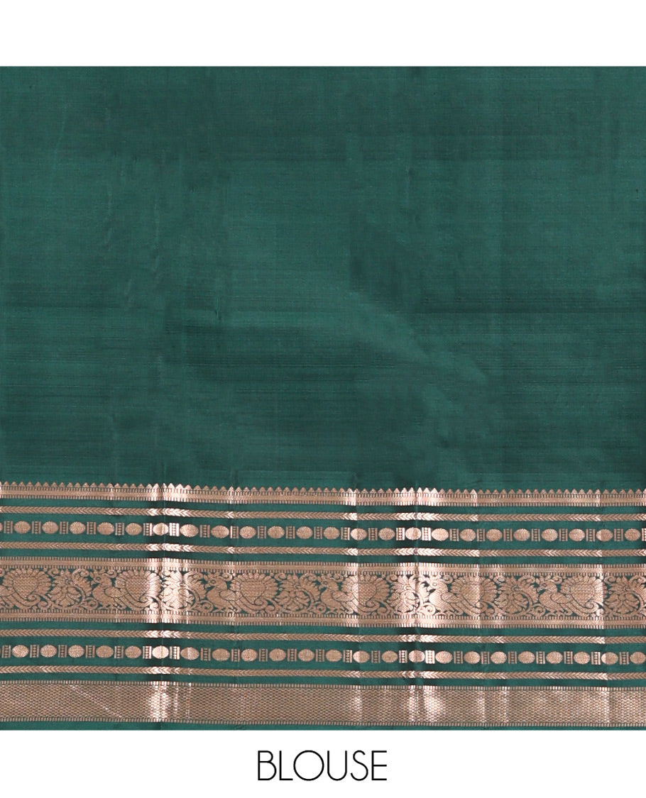 Gold Vasundhara Silk Saree, Bedecked with Zari Buttas All Over Its Body, Complemented by a Contrast Border of Rekku, Muthu, Kathir, Poun, Mayil, and Mayil Kann Designs, Grand Jaal Pallu, and Paired with a Contrast Blouse