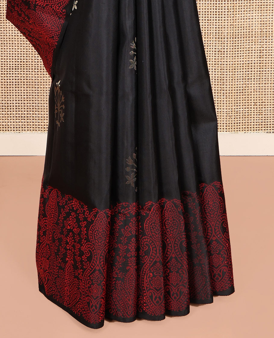 Black Mayuri Soft Silk Saree, Adorned with Zari Buttas, a Self-Border, and a Pallu Features an Intricate Thread Weave, and a Matching Blouse