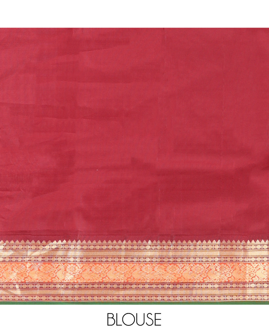 Green Vasundhara Silk Saree, Sparsely Woven with Zari Buttas All Over Its Body, Complemented by a Contrast Border of Rekku, Poun, Kathir, and Mayil Designs, Pallu Steeped with the Same Border Designs, and Paired with a Contrast Blouse