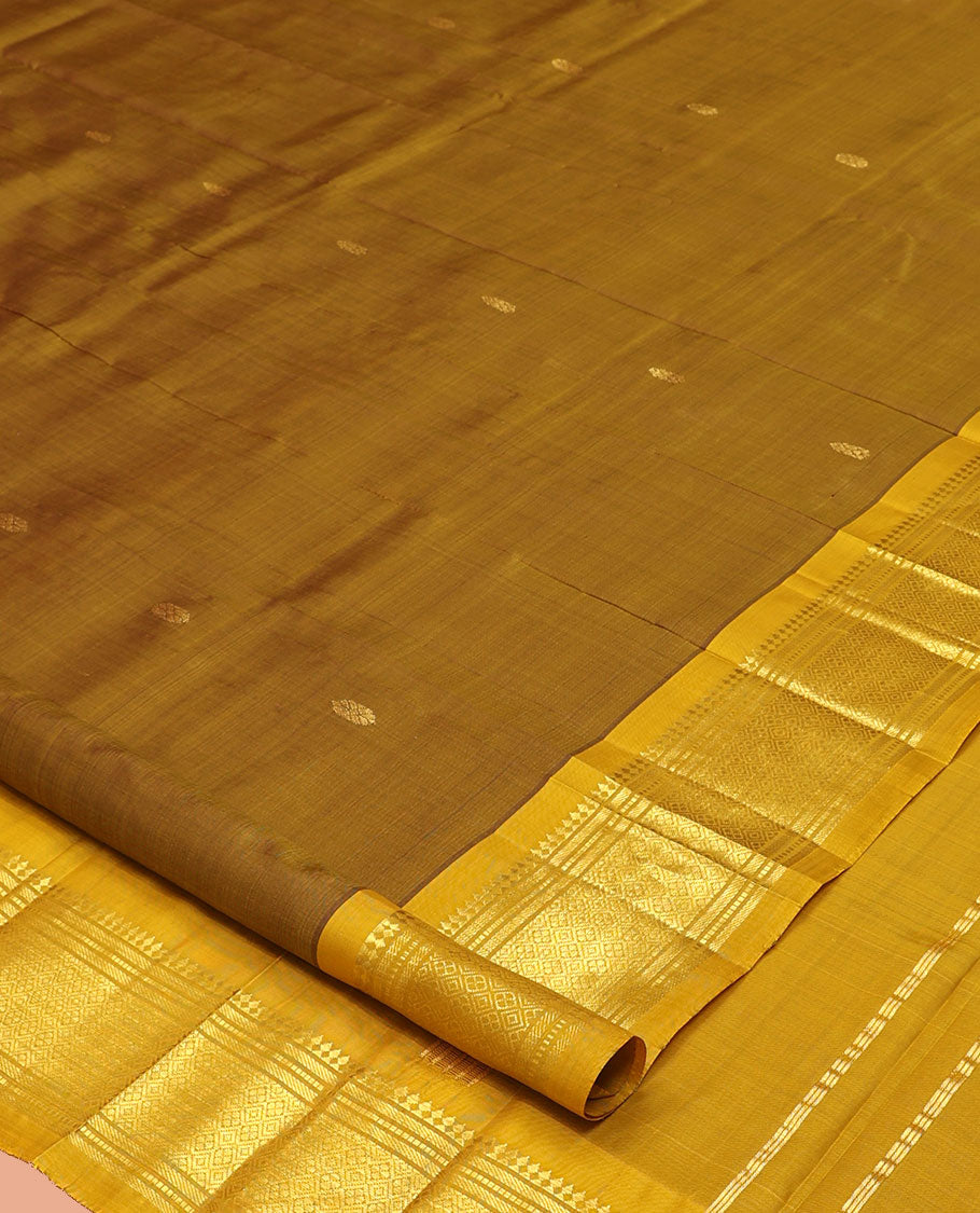 Green Kanchipuram Silk Saree, Elevated with Zari Buttas, a Contrast One-Sided Border of Paneer Sombu, Banaras, Muthu, and Jaal Designs, a Zari Design Pallu, and No Blouse