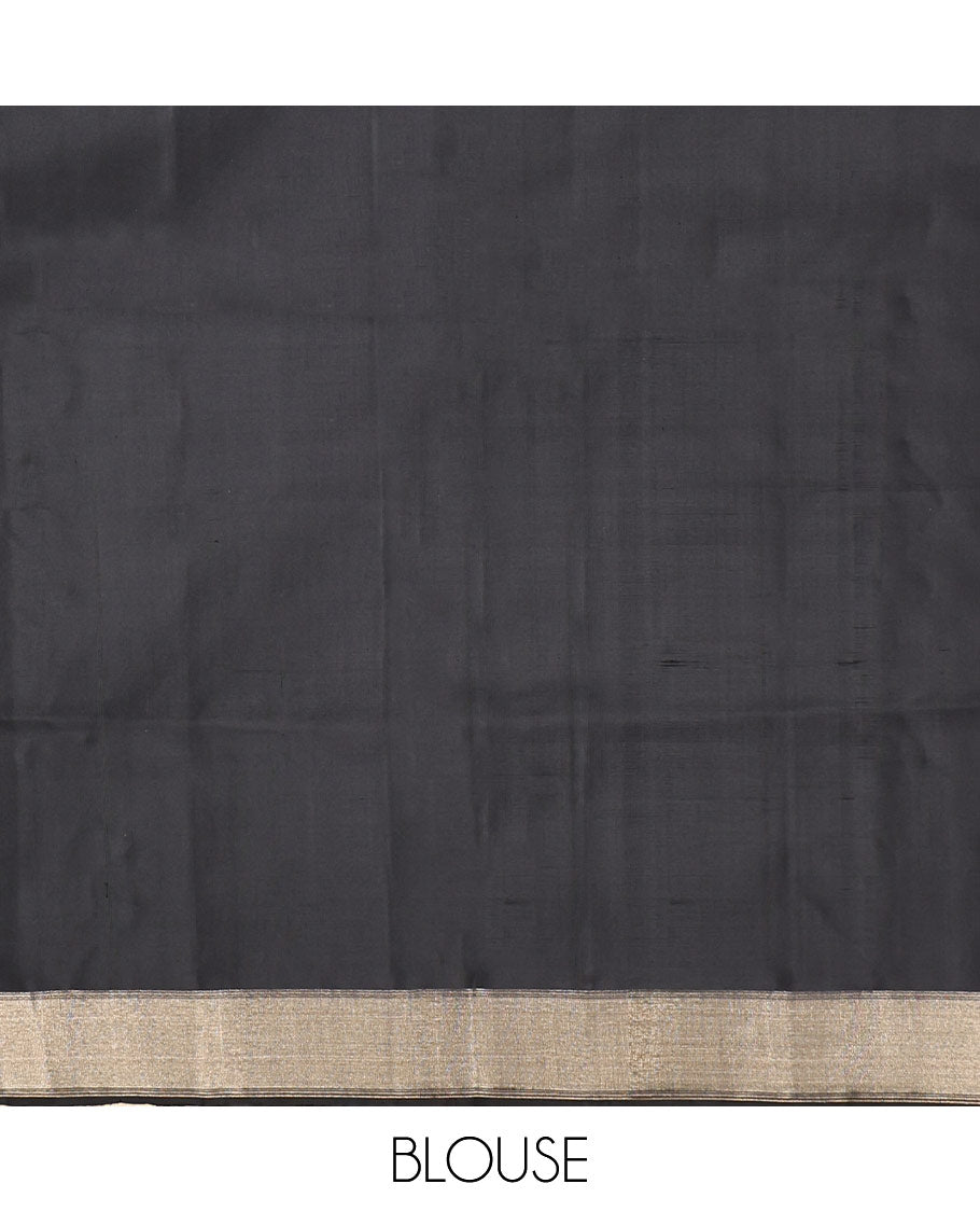 Black Mayuri Soft Silk Saree, Adorned with Zari Buttas, a Self-Border, and a Pallu Features an Intricate Thread Weave, and a Matching Blouse