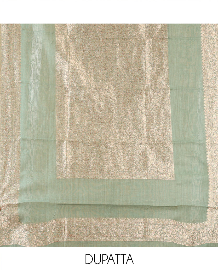 Green Banarasi Material Chudidar Features Jacquard Top, a Matching Santoon Bottom, and an Intricately Designed Dupatta