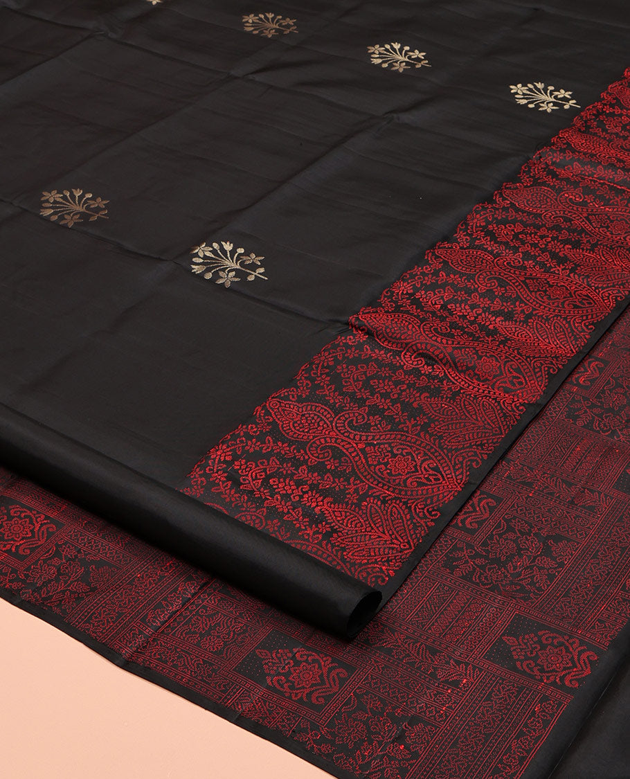 Black Mayuri Soft Silk Saree, Adorned with Zari Buttas, a Self-Border, and a Pallu Features an Intricate Thread Weave, and a Matching Blouse