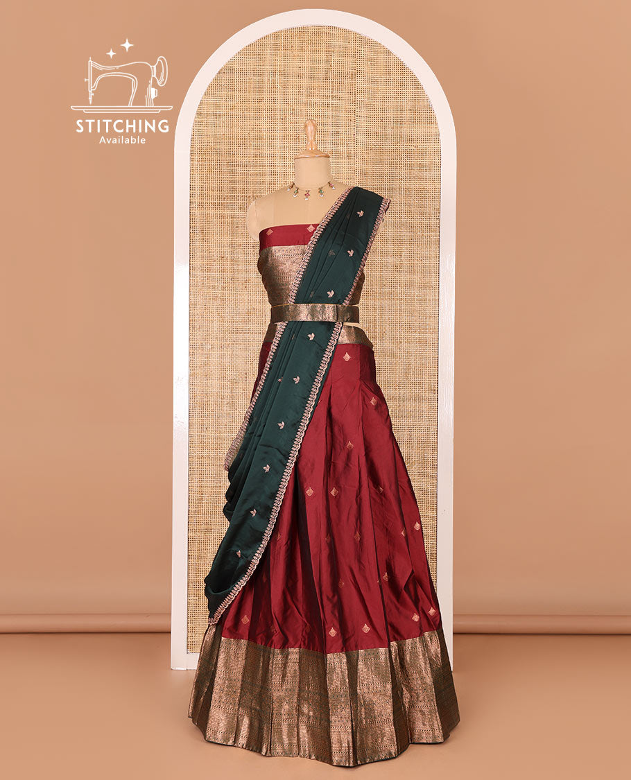 Maroon taffeta silk half-saree, zari buttas and contrast traditional zari bordered skirt, a matching blouse, and contrast embroidered satin georgette dhavani