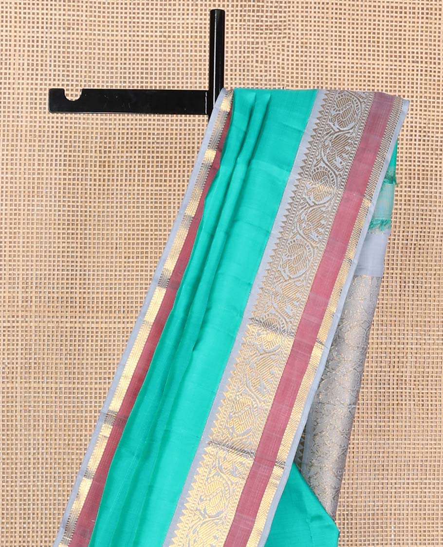 Turquoise plain Kanchipuram korvai silk saree, contrast neer korvai border of rekku, muthu, banaras, and kodi mayil and yaanai designs, and floral jaal pallu