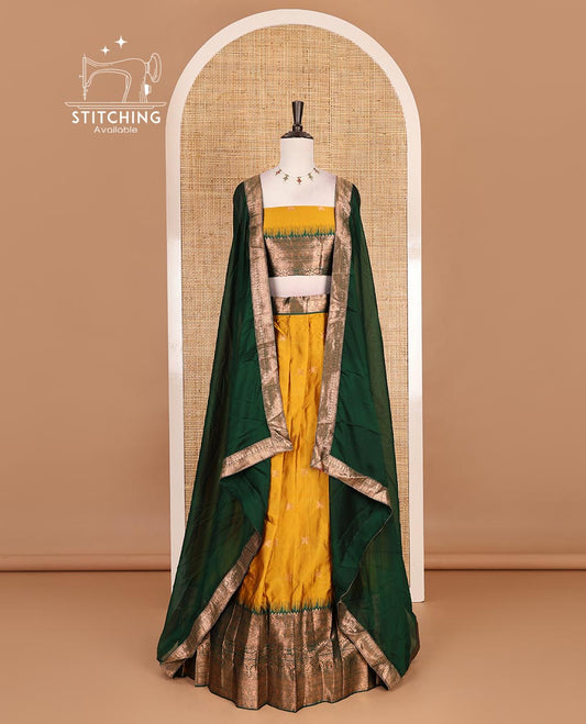 Mustard taffeta silk half saree, zari buttas with contrast green traditional zari border skirt, matching zari design blouse, and contrast plain zari border syska georgette dhavani