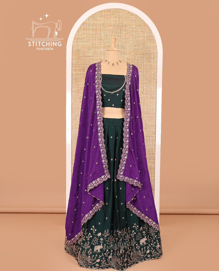 Bottle green half-saree, buttas and flora-fauna embroidered bordered velvet organza skirt, a matching velvet organza blouse, and a contrast embroidered scallop syska georgette dhavani