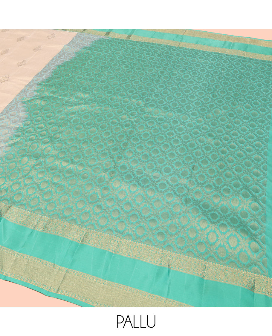 Cream Vasundhara Lite Silk Mix Saree, Gracefully Embellished with Zari Buttas All Over Its Body, Complemented by a Contrast Rettai Pettu Border of Thilakam Mokku, Kodi Visiry, and Kamalam Designs, Grand Jaal Design Pallu, and Paired with a Contrast Blouse