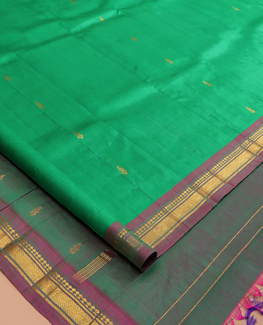 Green Kanchipuram Silk Saree, Woven with Zari Buttas, a Contrast One-Sided Border of Panner Sombu, Banaras, and Mayil Kann Designs, Zari Design Pallu, and No Blouse