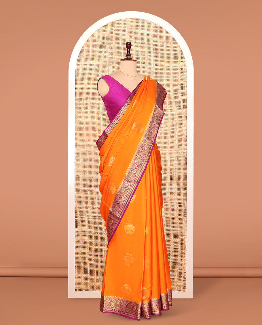 Orange Mysore Silk Saree, Bedecked with Zari Buttas All Over Its Body, Complemented by Captivating Contrast Border of Traditional Zari Designs, Gleaming Zari Striped Pallu, and Paired with a Contrast Blouse