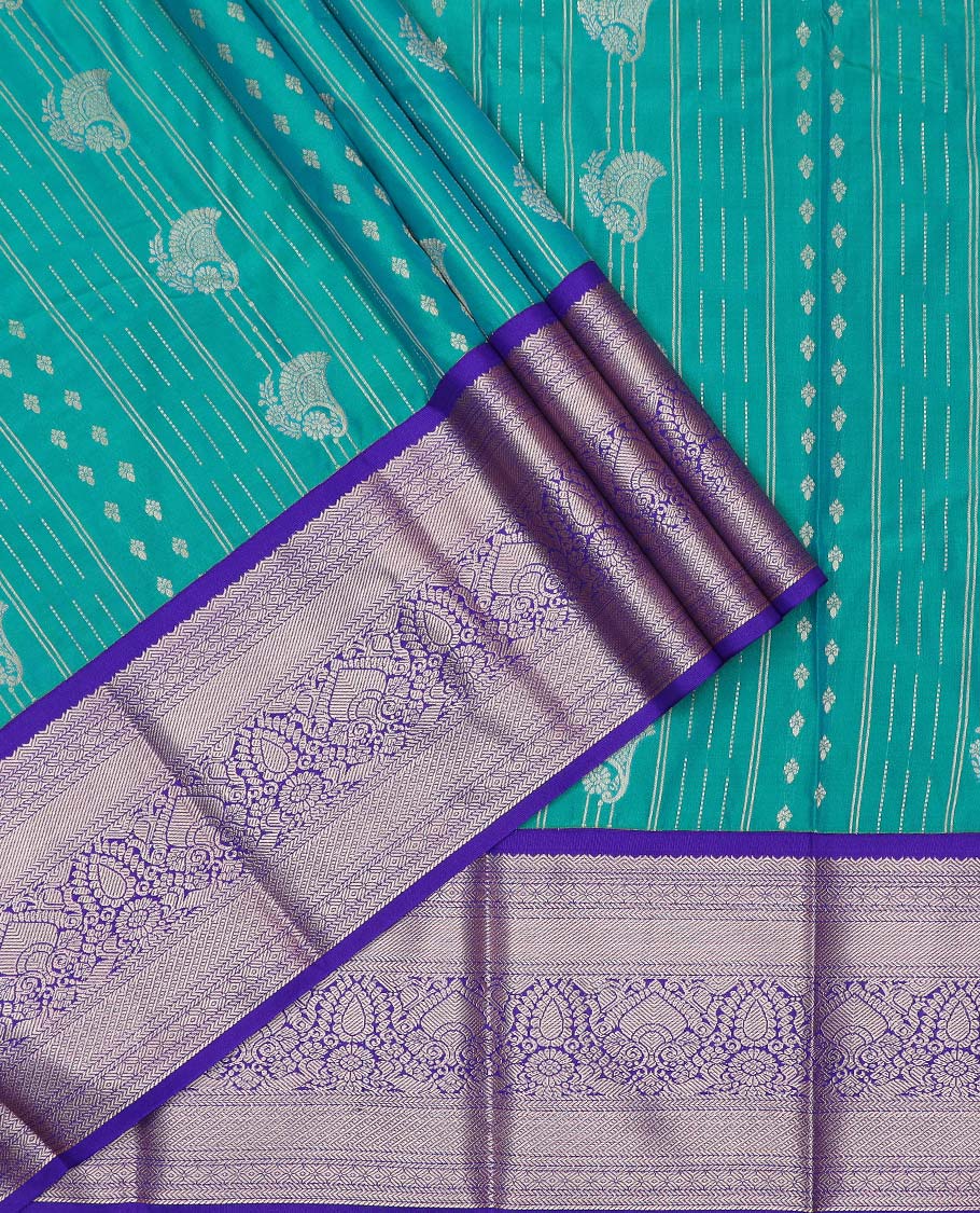 Green art silk pavadai material, zari design with contrast traditional zari bordered skirt, and a contrast bordered blouse