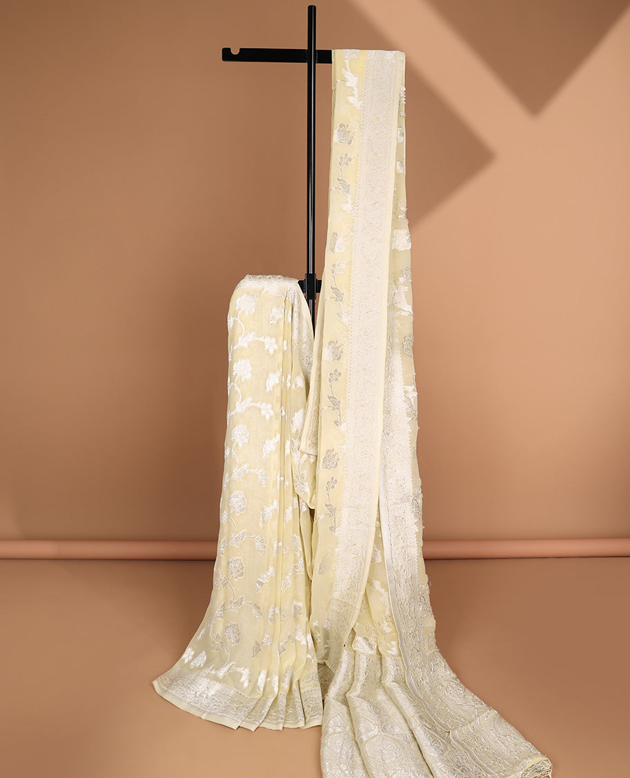 Pale yellow floral jacquard semi-banaras crepe saree, floral creeper border & intricate pallu