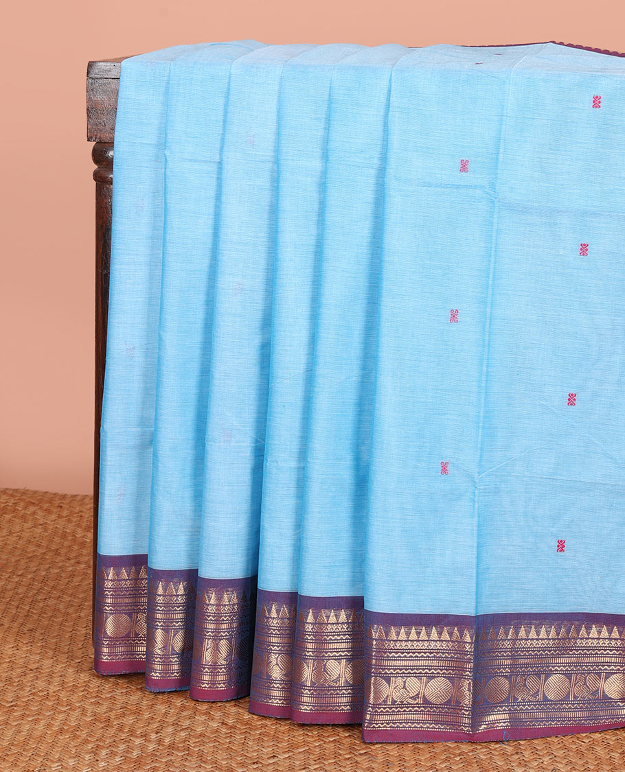 Blue Chettinad Cotton Saree Decked up with Buttas All Over Its Body, Complemented by a Contrast Border of Traditional Zari Designs, and Pallu Features Stripes and Buttas