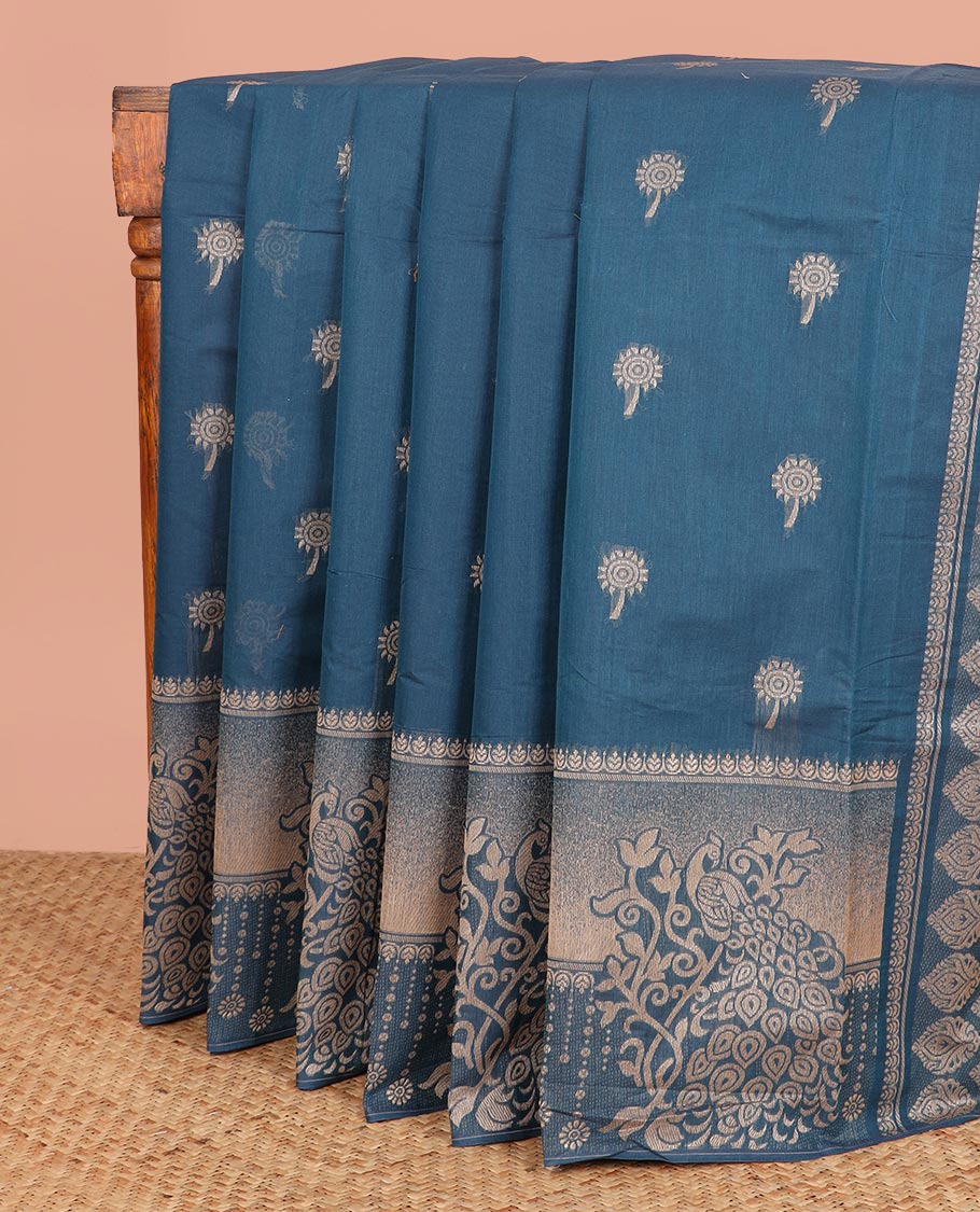 Blue Coimbatore Cotton Saree Features Floral Buttas All Over Its Body, a Subtle Self-Border of Peacock Designs, Pallu Depicts Geometric Patterns, and Is Paired with a Matching Blouse
