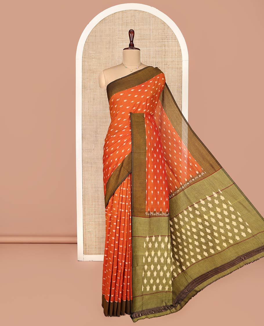 Orange Ikkat Cotton Saree, Accentuated with Ikkat-Style Buttas on Its Body, Complemented by Contrast Ikkat-Textured Border, Pallu Steeped with Ikkat Buttas, and Has No Blouse
