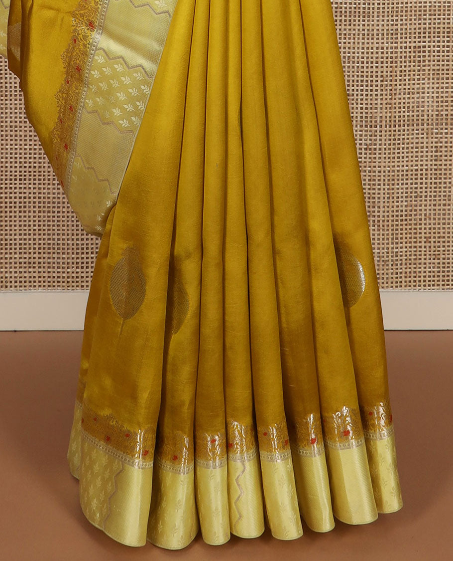 Mustard unblossomed flower-shape zari buttas raw mango silksaree,satin embossed border of meenakari zari floral vine & scallop jacquard pallu