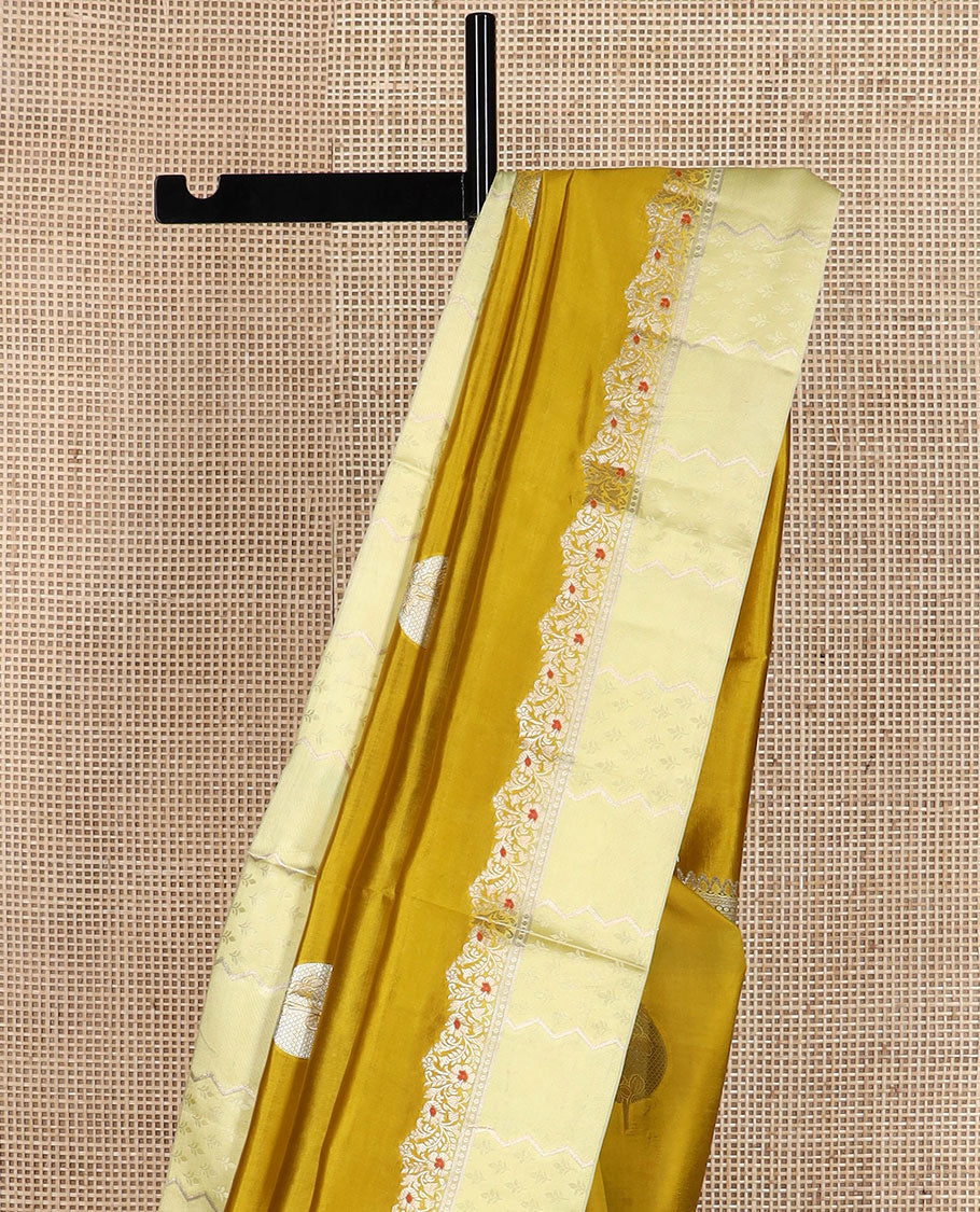 Mustard unblossomed flower-shape zari buttas raw mango silksaree,satin embossed border of meenakari zari floral vine & scallop jacquard pallu
