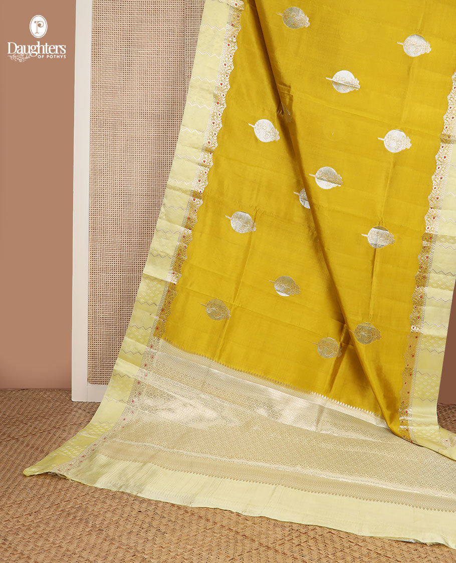 Mustard unblossomed flower-shape zari buttas raw mango silksaree,satin embossed border of meenakari zari floral vine & scallop jacquard pallu