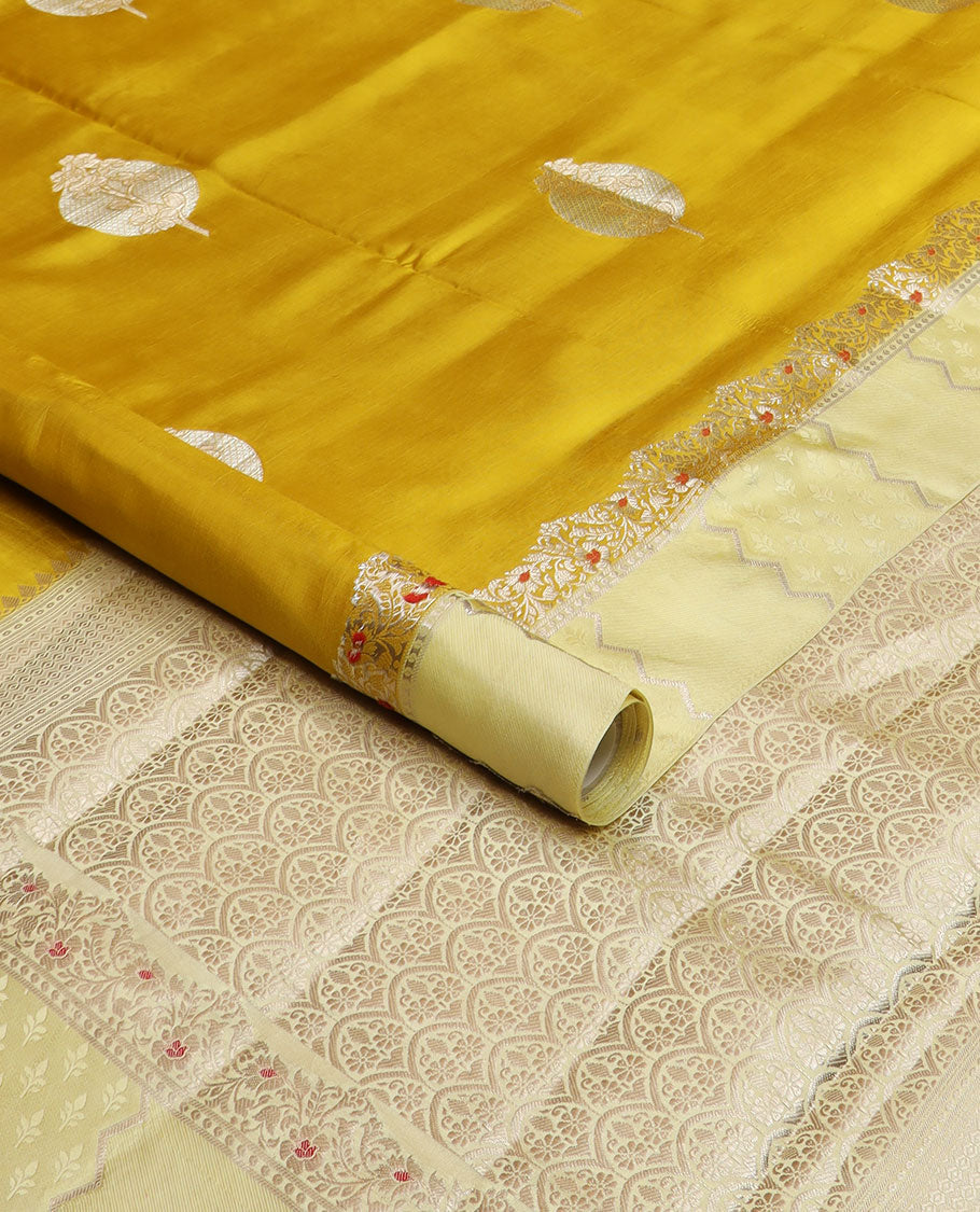 Mustard unblossomed flower-shape zari buttas raw mango silksaree,satin embossed border of meenakari zari floral vine & scallop jacquard pallu