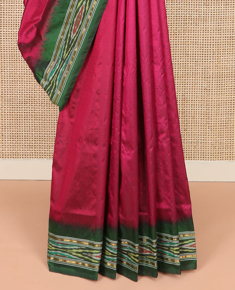 Magenta Plain Ikkat Silk Saree with a Contrast Green Border Complemented by a Hazy Ikkat Weave, Featuring a Pallu Flanked by Stripes and Ikkat Texture