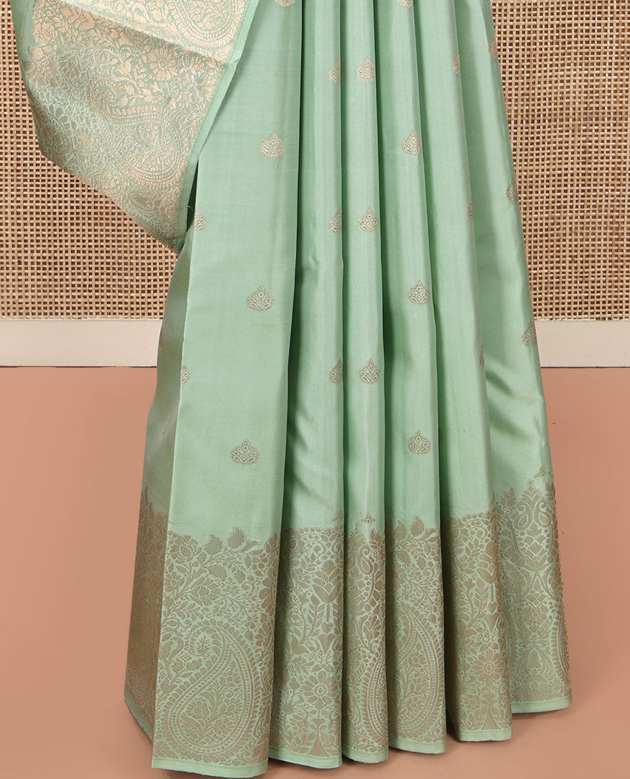 Green Kanchipuram Silk Saree, Delicately Woven with Zari Buttas All Over Its Body, Highlighted by a Zari Border of Floral and Paisley Designs, Grand Chevron Striped Pallu, and Paired with a Matching Blouse