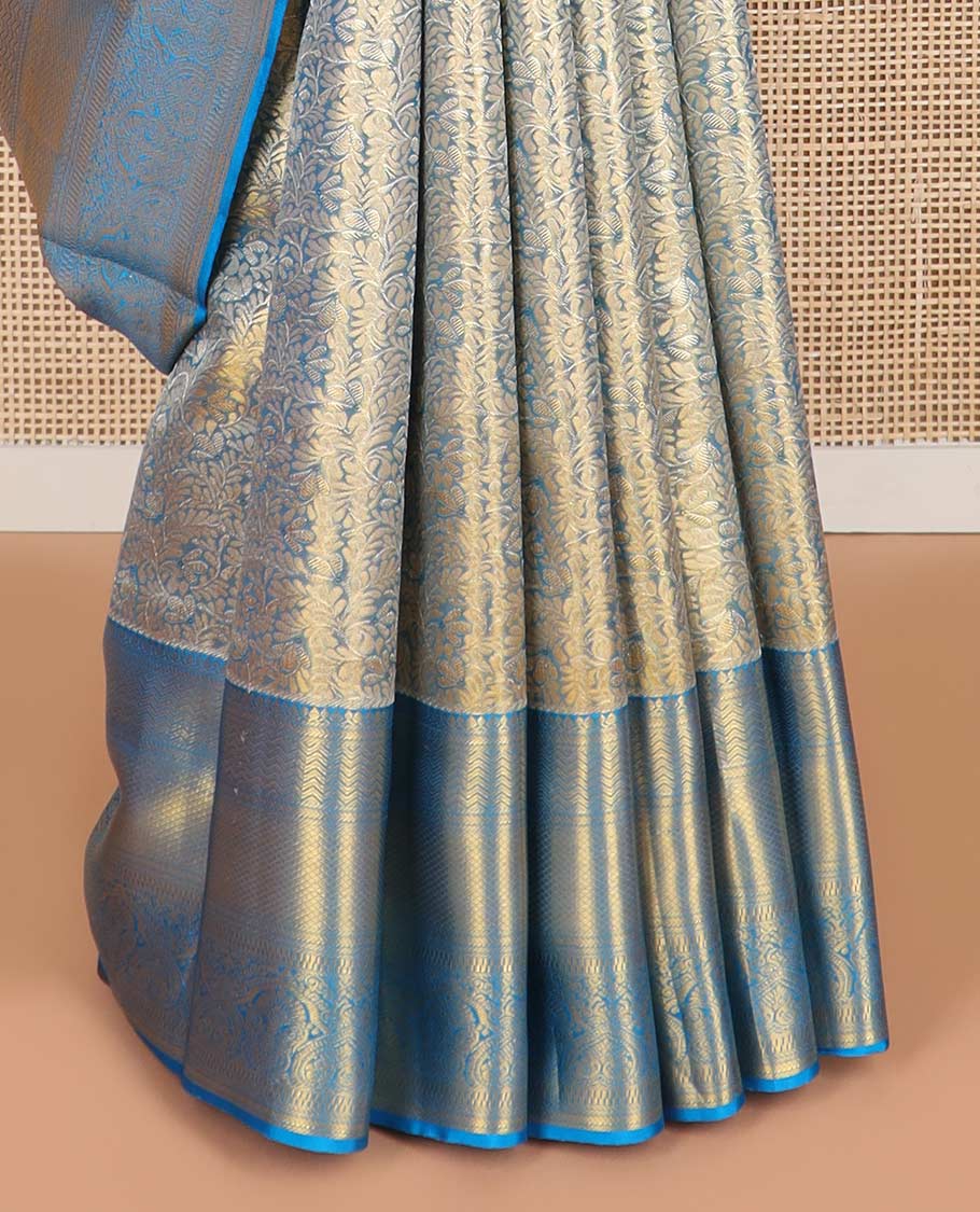 Blue floral jacquard kancheepuram tissue silk saree with contrast korvai border of thilakam mokku, kathir, mayil kann design & zari design pallu