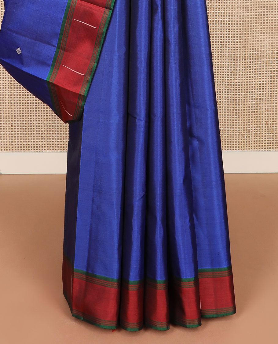 Royal blue buttas Kanchipuram silk saree, contrast border of malli mokku designs, and pallu of geometric designs