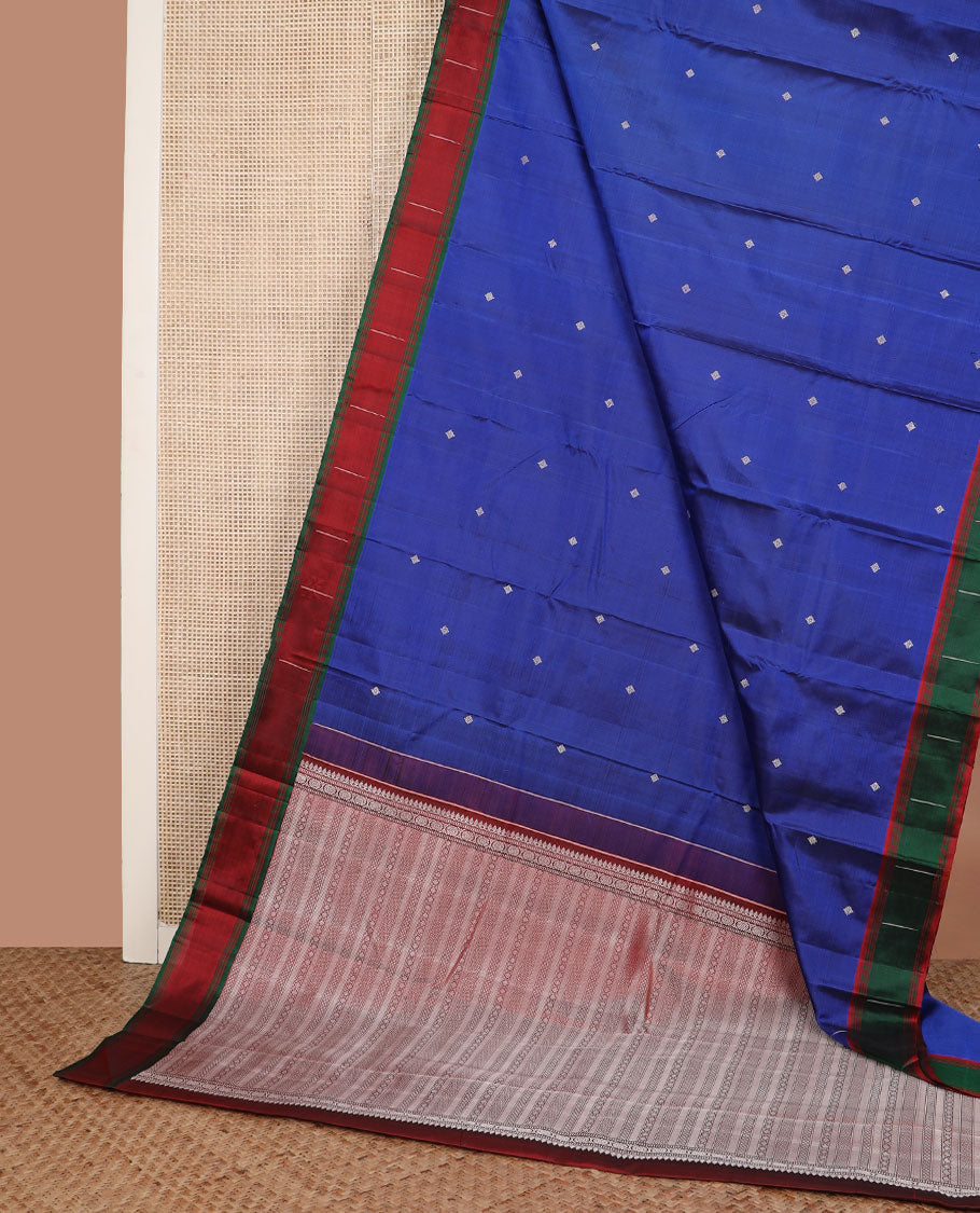 Royal blue buttas Kanchipuram silk saree, contrast border of malli mokku designs, and pallu of geometric designs