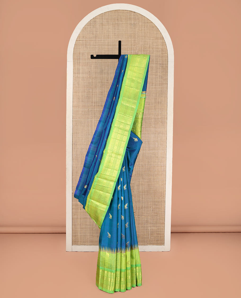 Blue Kanchipuram Silk Saree, Bedecked with Yaanai Buttas, Complemented by Contrast One-Sided Checked Border of Thazanpoo Rekku, Salngai, Banaras, Lavangam, and Laddu Kamalam Designs, Pallu of Floral Designs, and Comes Without a Blouse
