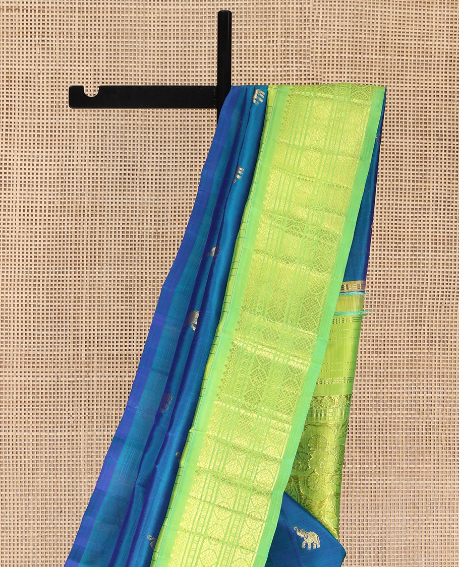 Blue Kanchipuram Silk Saree, Bedecked with Yaanai Buttas, Complemented by Contrast One-Sided Checked Border of Thazanpoo Rekku, Salngai, Banaras, Lavangam, and Laddu Kamalam Designs, Pallu of Floral Designs, and Comes Without a Blouse