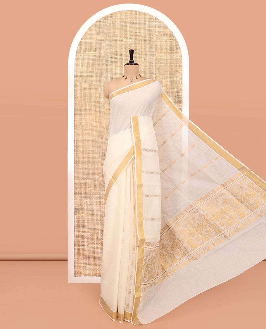 Cream Kerala Cotton Saree, Spotlighted with Zari Stripes All Over Its Body, a Subtle Bavanji Border, Pallu of Intricate Designs, and Is Paired with a Matching Blouse