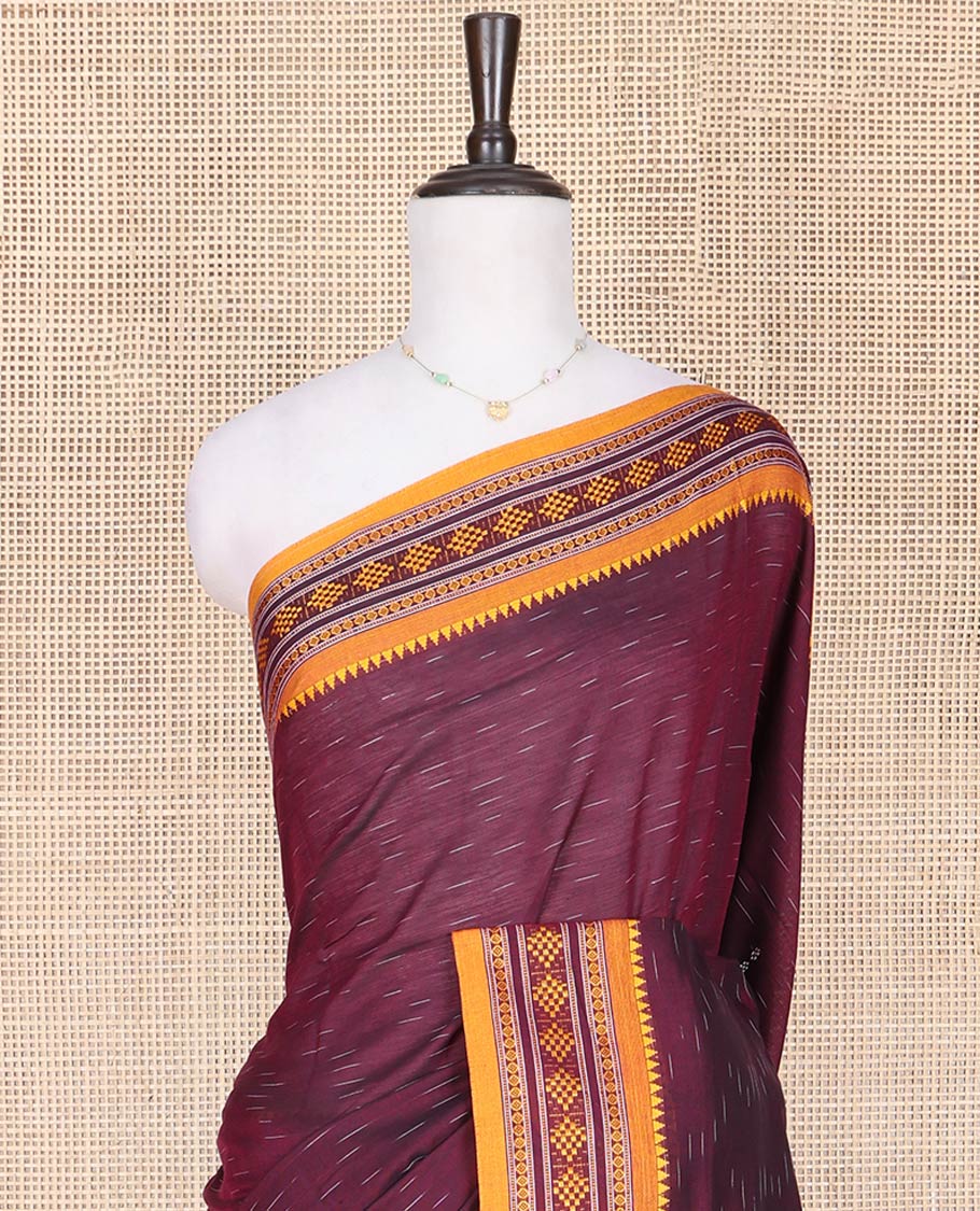 Wine Odisha Cotton Saree, Subtly Woven with Buttas All Over the Body, Complemented by a Contrast Temple Border of Geometric Thread Patterns, Pallu Depicts Geometric Patterns, and Paired with a Matching Blouse