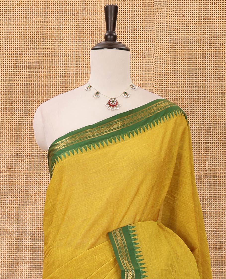 Mustard color plain design chettinadu cotton saree, contrast temple traditional design border, striped pallu & batik-printed blouse