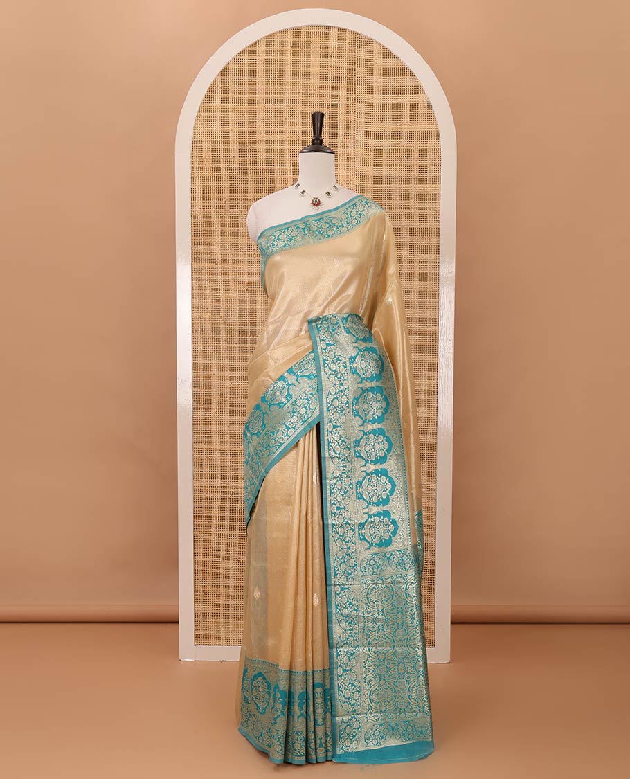 Cream color Antique buttas twill tissue saree, contrast satin thread woven border & pallu of mughal-style motifs & buttas green blouse