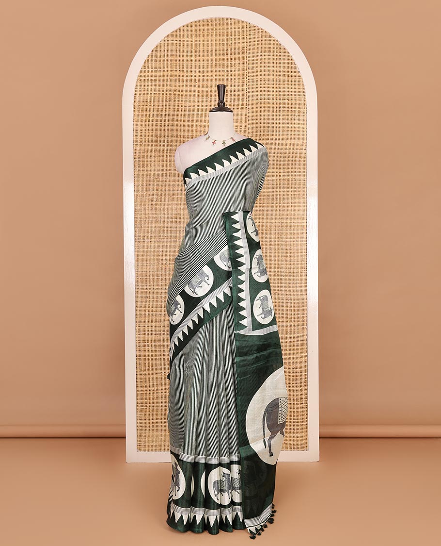 Cream-green vertically striped khadi cotton saree, contrast Pichwai cow printed temple border, Pichwai cow print pallu, and jaal printed blouse