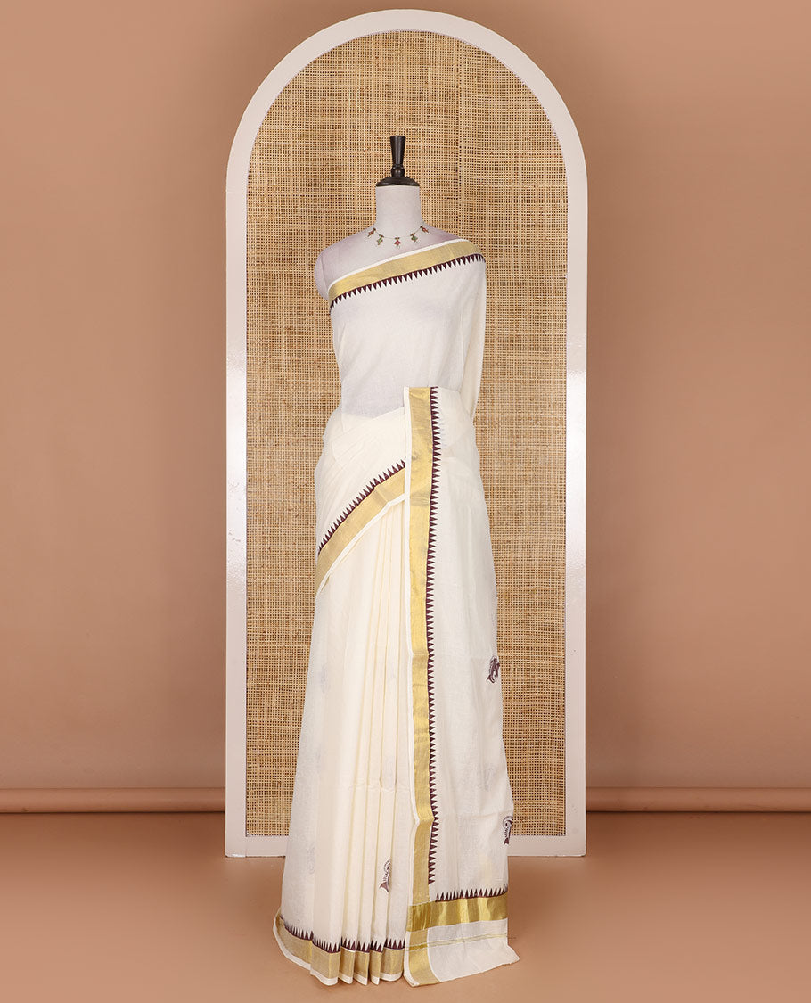 Half-white and maroon leaf motifs printed Kerala cotton saree, temple gold zari border, gold zari pallu, and matching blouse