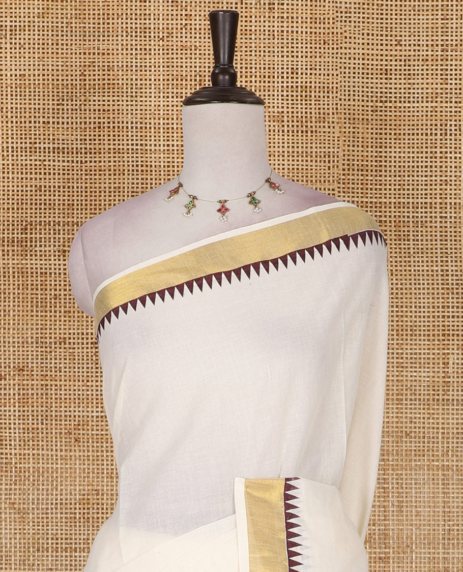 Half-white and maroon leaf motifs printed Kerala cotton saree, temple gold zari border, gold zari pallu, and matching blouse