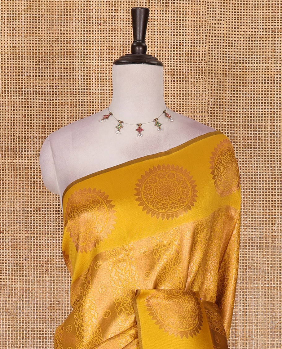 Yellow jacquard kanchi tissue saree, zari chakram motifs border, intricately zari woven pallu, and a matching zari design blouse