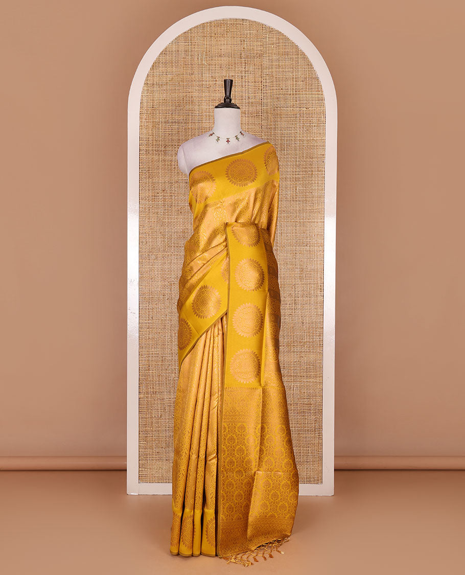 Yellow jacquard kanchi tissue saree, zari chakram motifs border, intricately zari woven pallu, and a matching zari design blouse