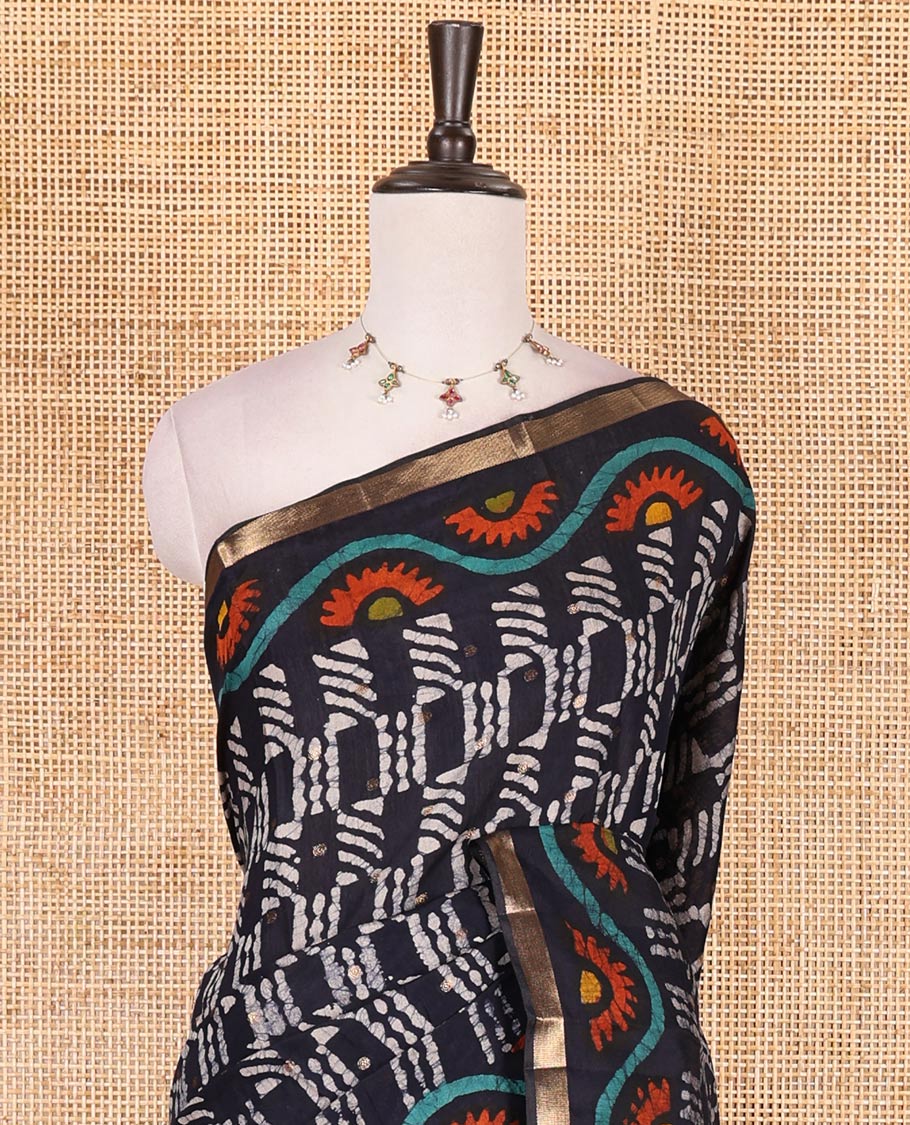 Navy blue batik printed with zari buttas woven chanderi cotton saree, zari piping border, batik printed pallu, and batik printed matching blouse