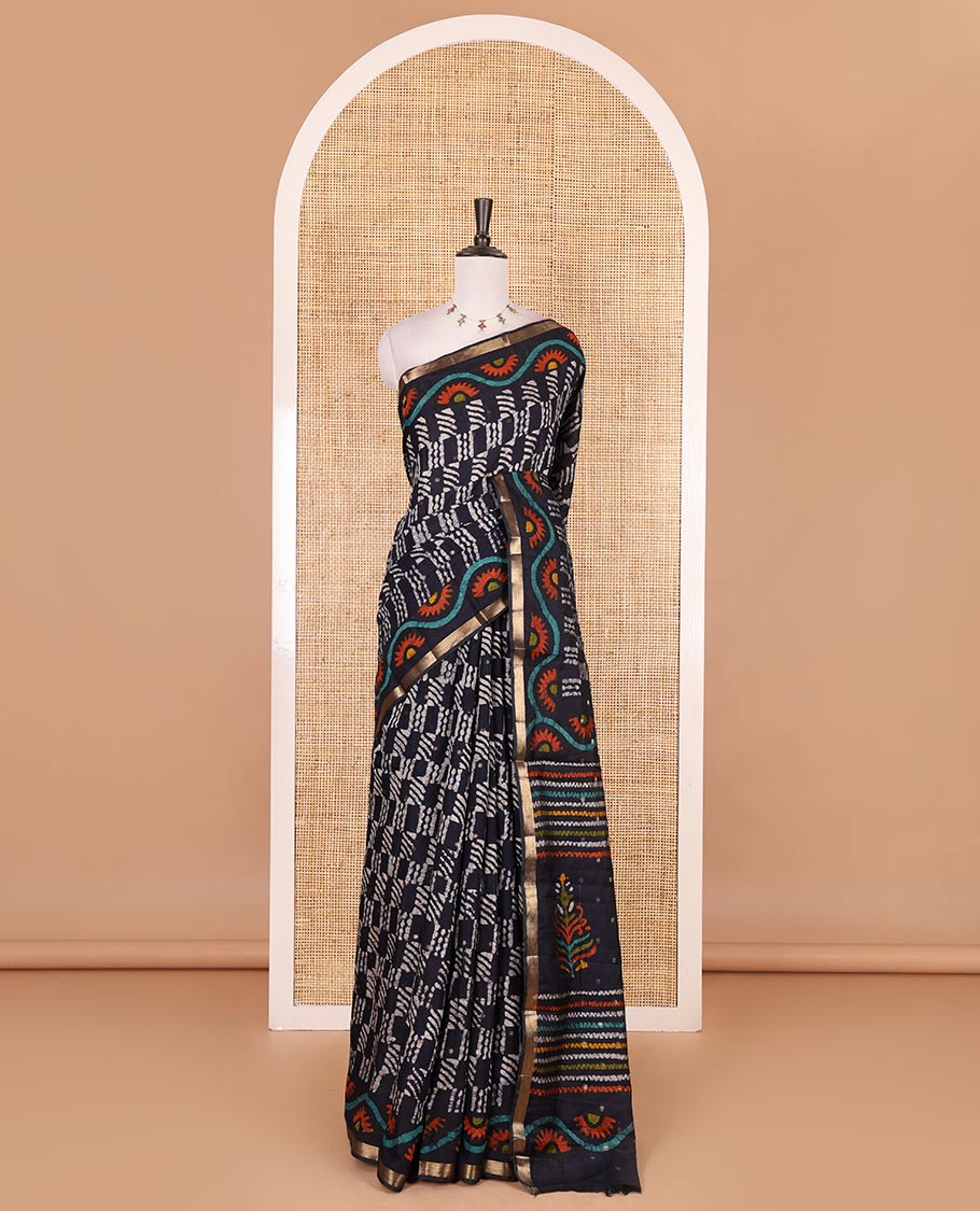 Navy blue batik printed with zari buttas woven chanderi cotton saree, zari piping border, batik printed pallu, and batik printed matching blouse