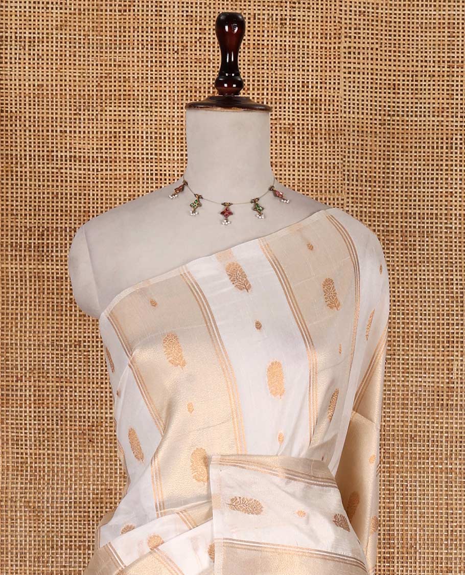 Borderless half-white traditional zari motifs steeped elite soft silk saree, floral jaal pallu, and matching zari buttas woven blouse