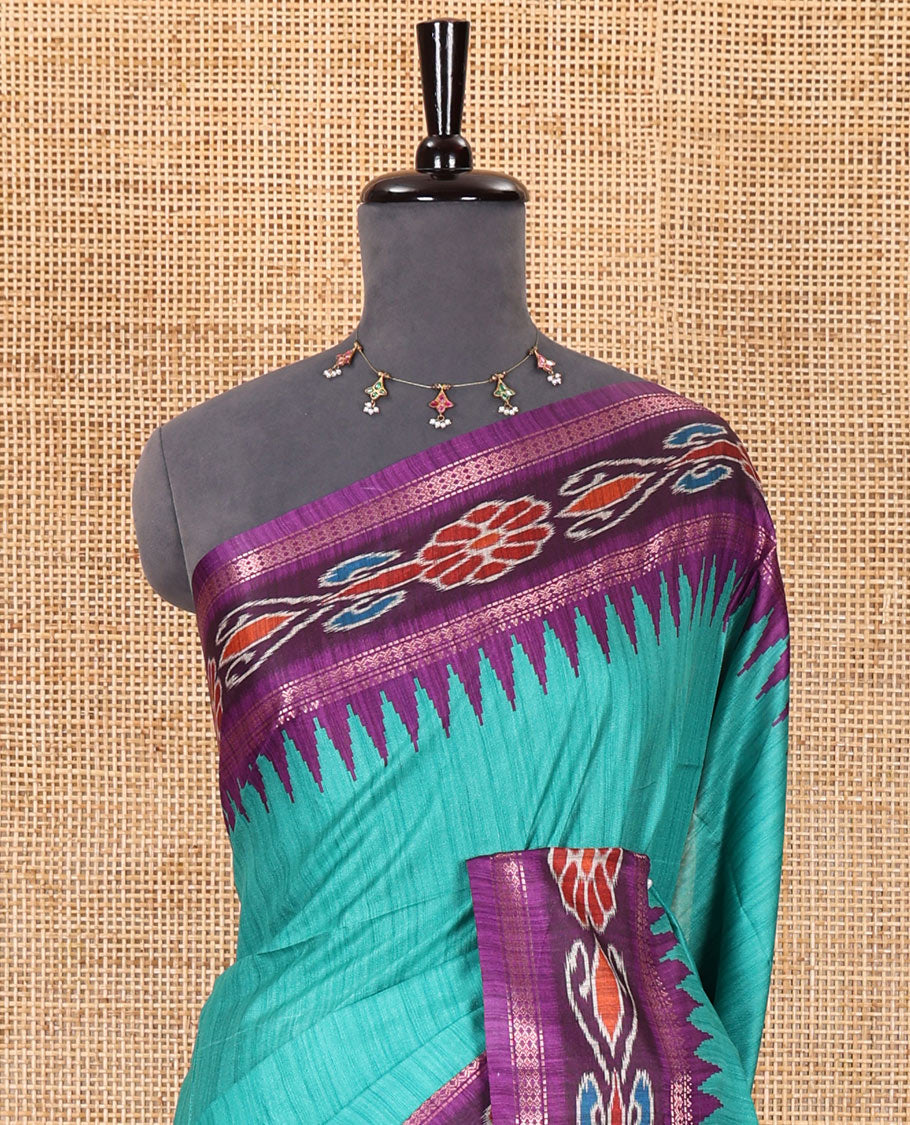 Rama green plain Katan silk saree, contrast temple ikkat floral printed border, ikkat floral printed pallu, and ikkat printed blouse