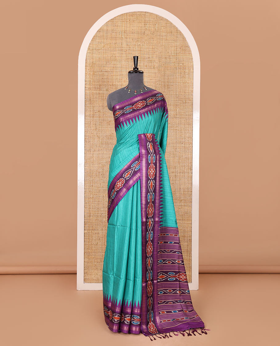 Rama green plain Katan silk saree, contrast temple ikkat floral printed border, ikkat floral printed pallu, and ikkat printed blouse