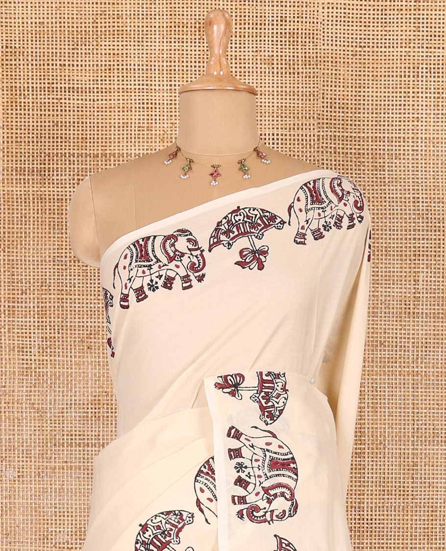 Cream plain South cotton saree, umbrella, and elephant motifs block printed border, block printed pallu, a matching blouse and a contrast floral vine block printed blouse